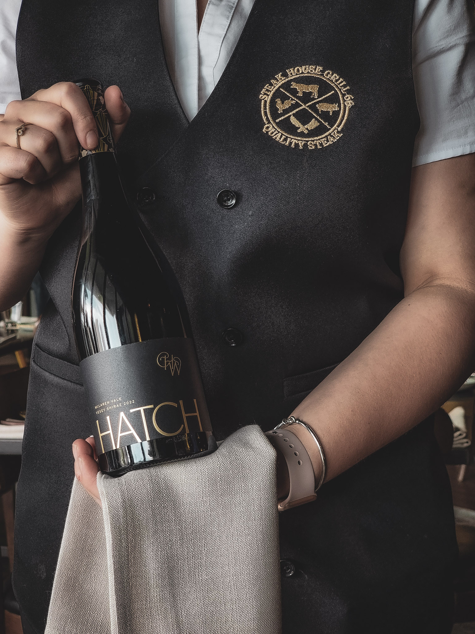 waitress with a bottle of red wine hatch
