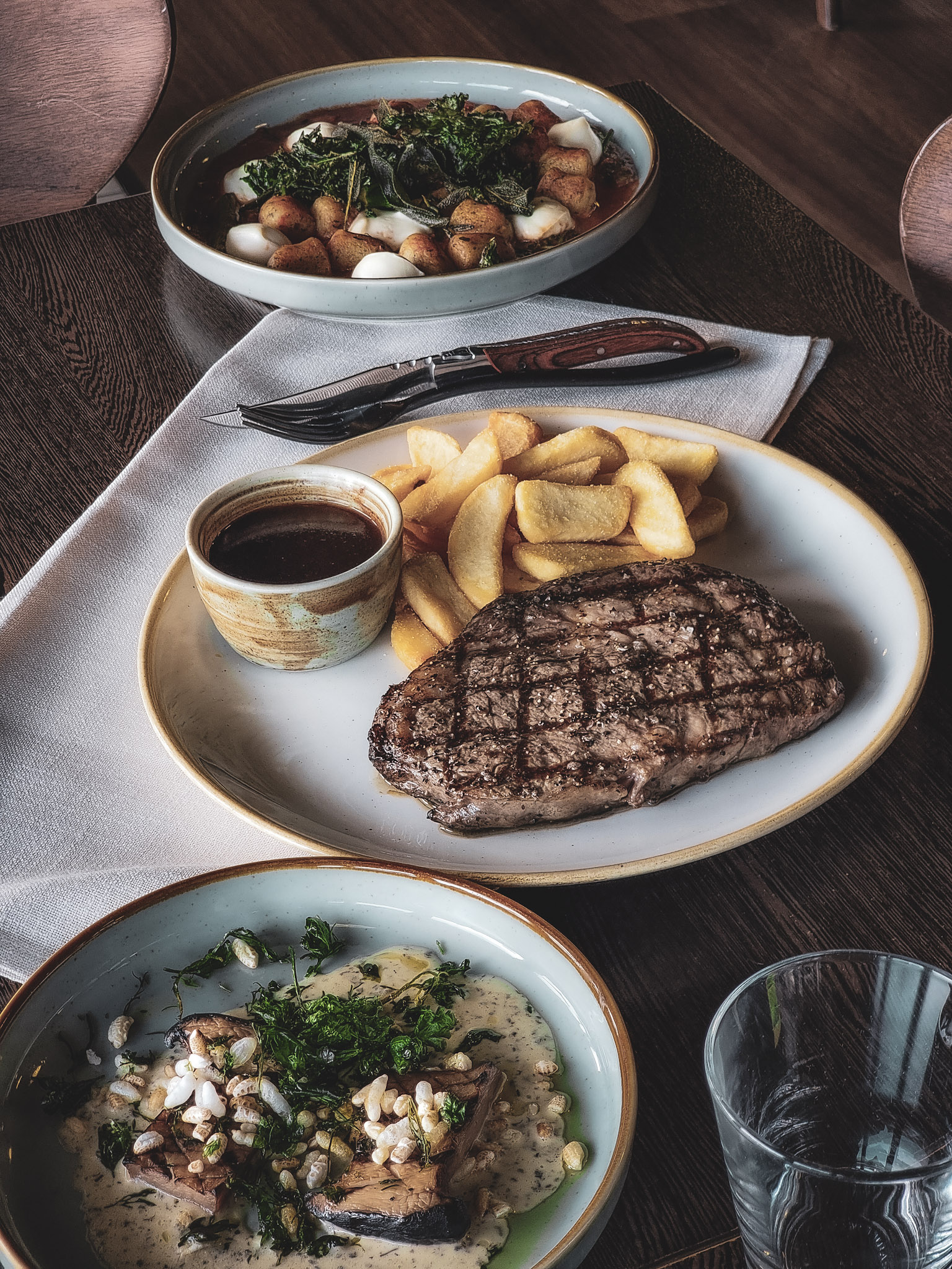 steak on the plate with fries and sauce